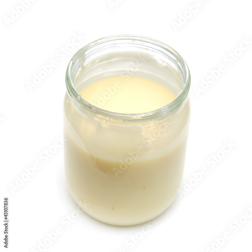 milk in a pot on a white background