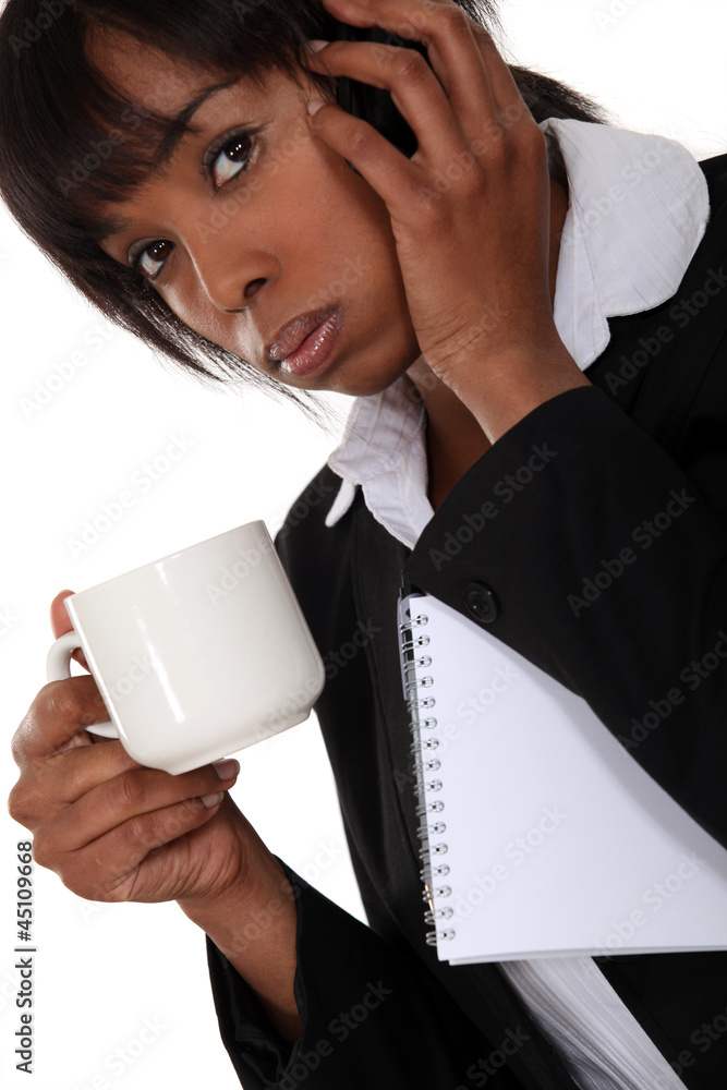 A businesswoman on the phone drinking a coffee. A businesswoman on the phone drinking a coffee.