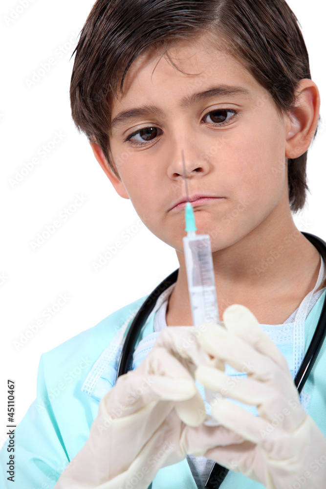 Little boy with syringe dressed as doctor Little boy with syringe dressed as doctor