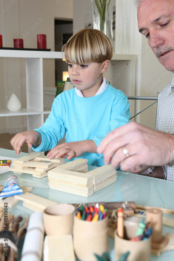 Fototapeta premium grandfather playing with his grandson