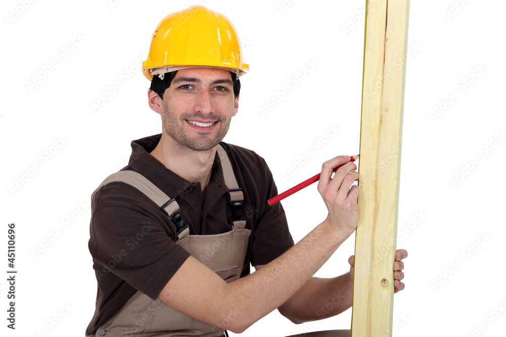 craftsman measuring a wooden piece