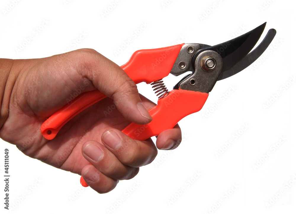 Garden scissors in hand isolated on a white background Garden scissors in hand isolated on a white background