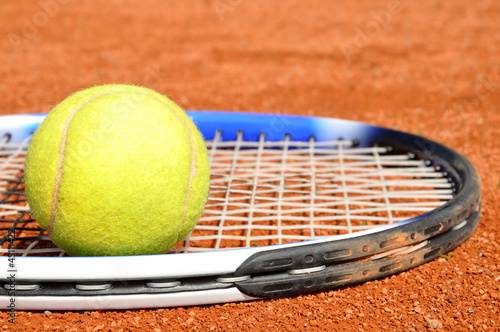 Tennis ball and racket on the court © vencav