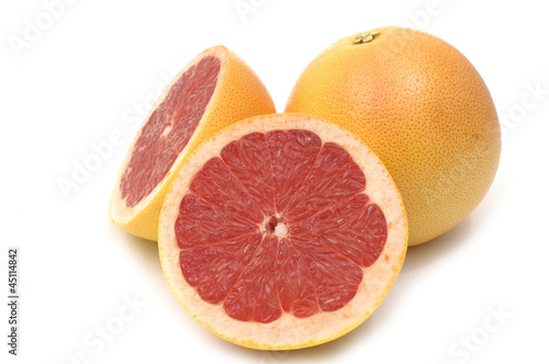 fresh grapefruit with cut on white