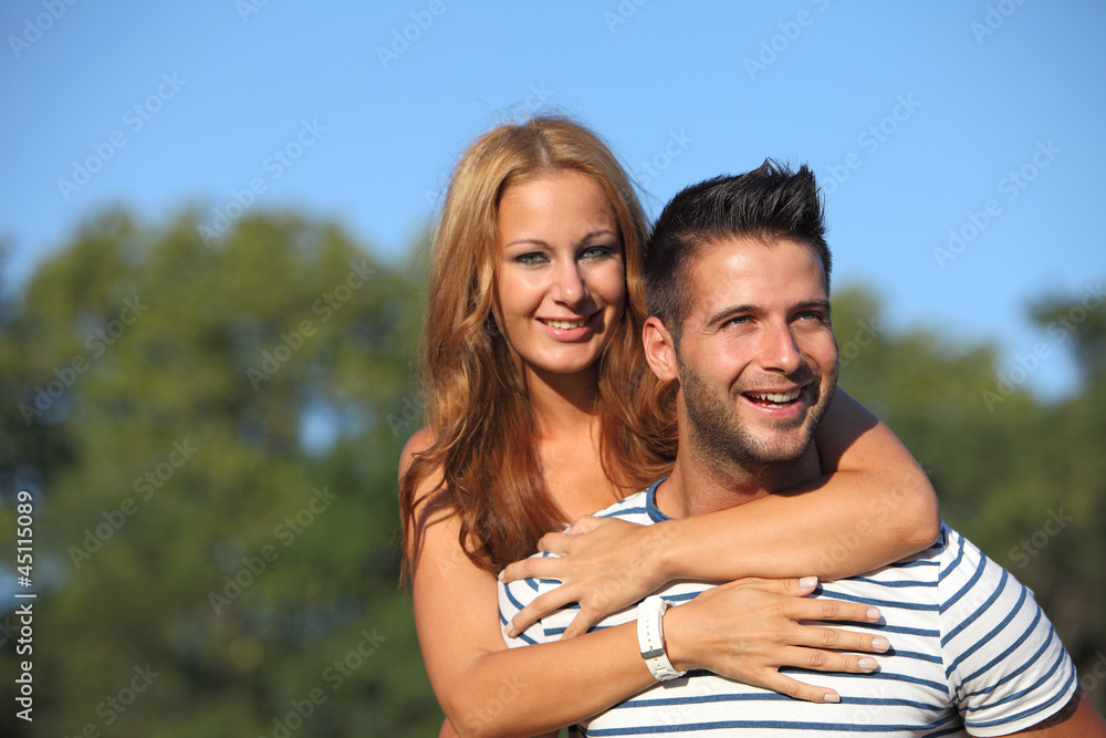 Happy young lovers having fun in the park Happy young lovers having fun in the park