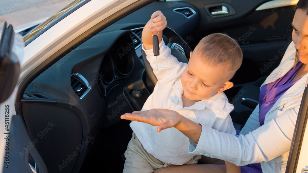Boy playing with his mothers car key