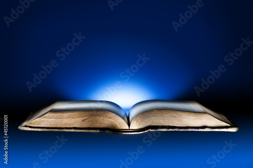 Old book, mystical blue light background