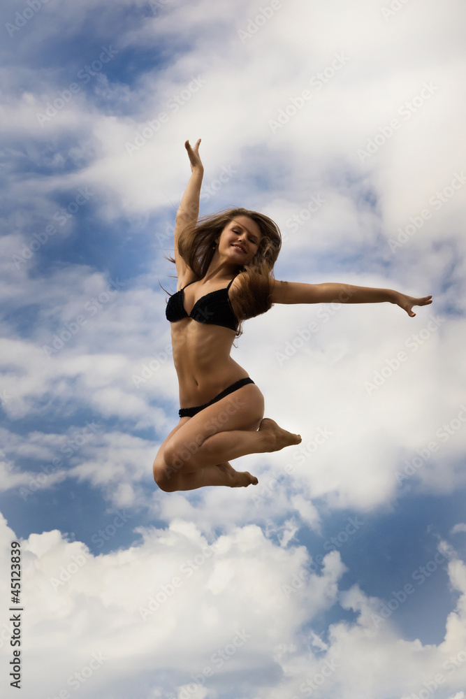 Happy girl on a blue sky background Happy girl on a blue sky background