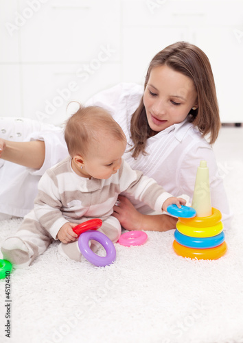 Young woman with baby girl playing