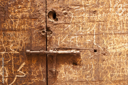 Particolar of an ancient door in the El Badi Palace in Marrakech photo
