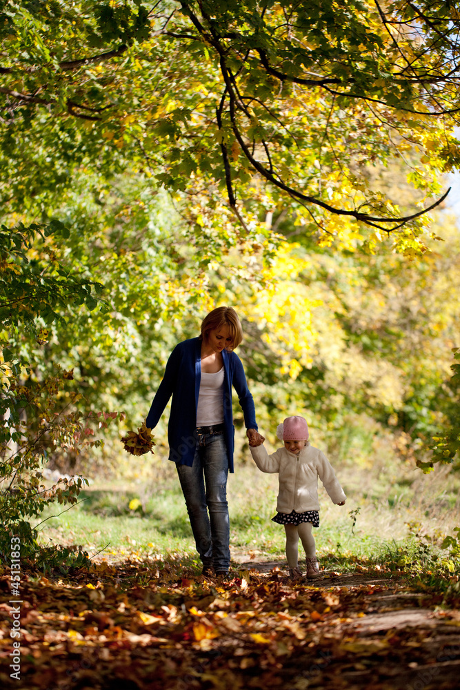 Mother and daughter walking in the forest Mother and daughter walking in the forest