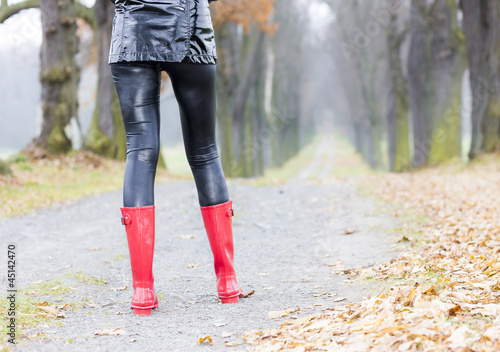 detail of woman wearing red rubber boots