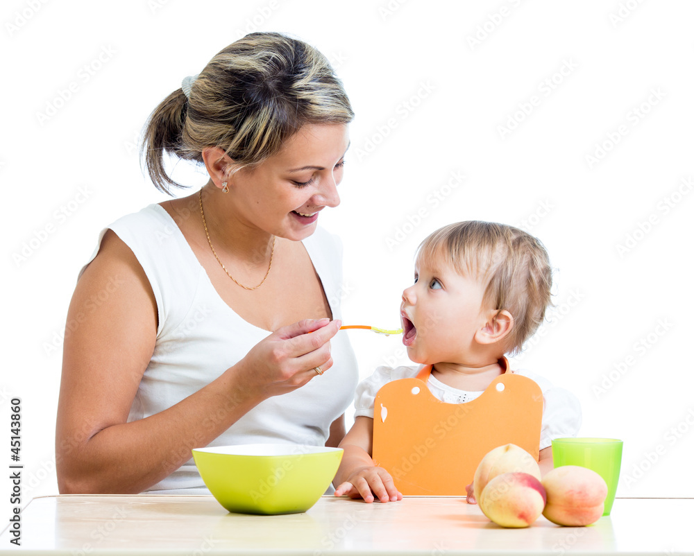 mother feeding her baby girl by spoon mother feeding her baby girl by spoon