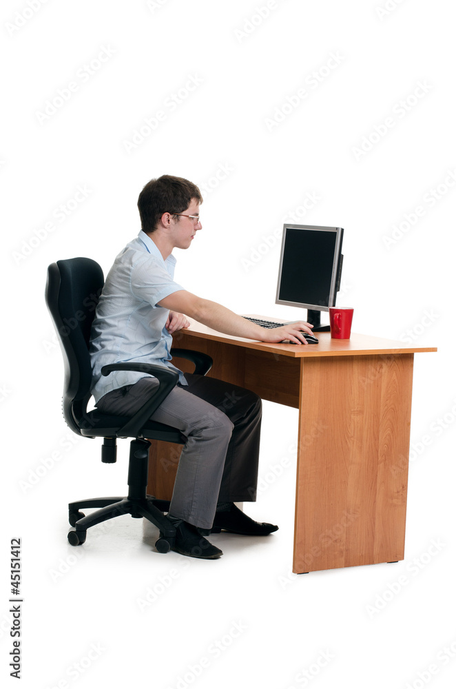 The businessman behind a table with the computer The businessman behind a table with the computer