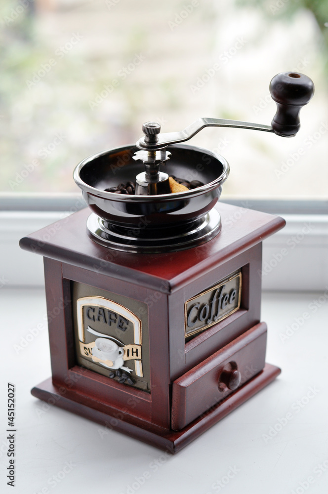 Old-fashioned coffee grinder with coffee beans Old-fashioned coffee grinder with coffee beans