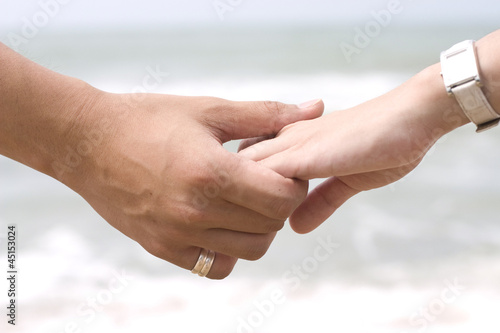 Hand Holding in Sea Background
