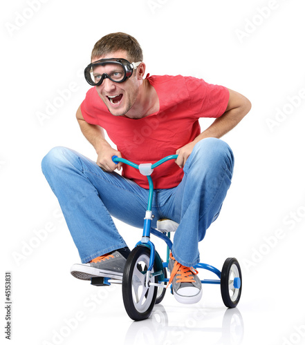 Bild auf Leinwand The curious man on a children's bicycle, on white background