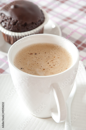 Chocolate muffins and coffee cup on table 