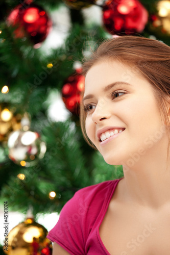happy and smiling woman with christmas tree