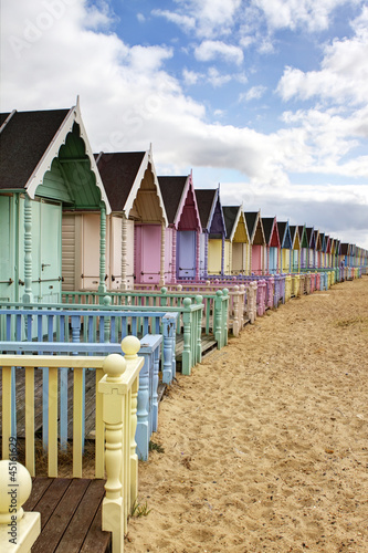 фотография Row of colourful beach huts in rural essex