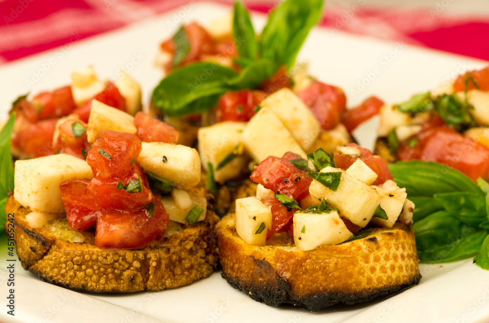 Fresh bruschetta with tomatoes mozzarella cheese and basil Fresh bruschetta with tomatoes mozzarella cheese and basil