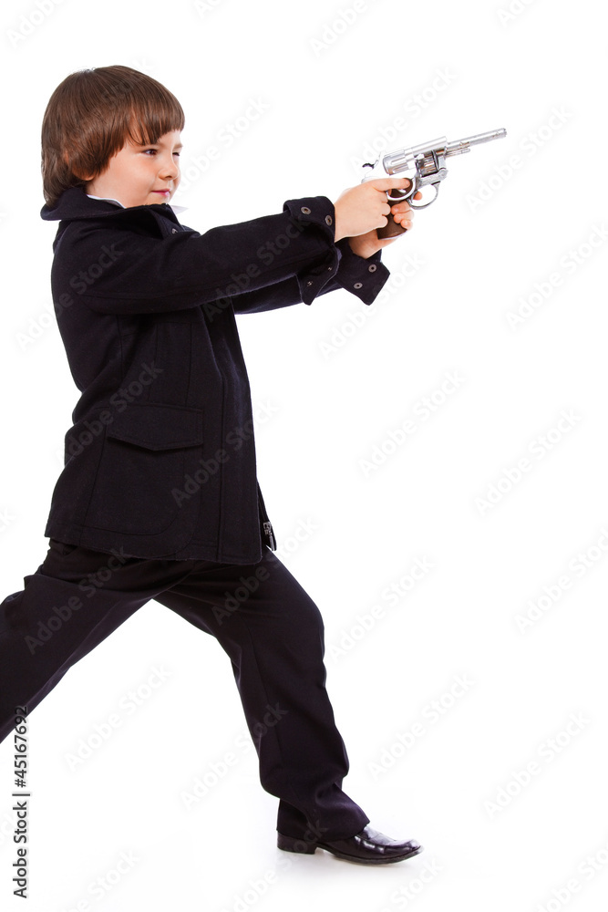 Portrait of handsome kid posing in studio with gun Portrait of handsome kid posing in studio with gun