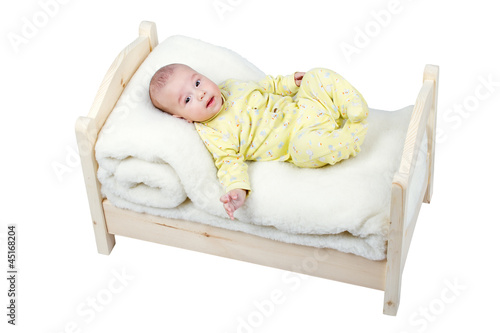 baby in wooden crib