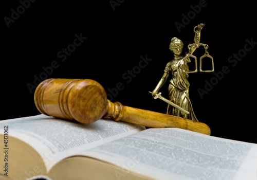 statue of justice on a black background