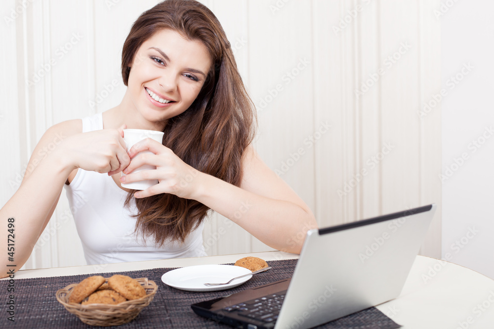 Happy woman enjoying tea and cookies Happy woman enjoying tea and cookies