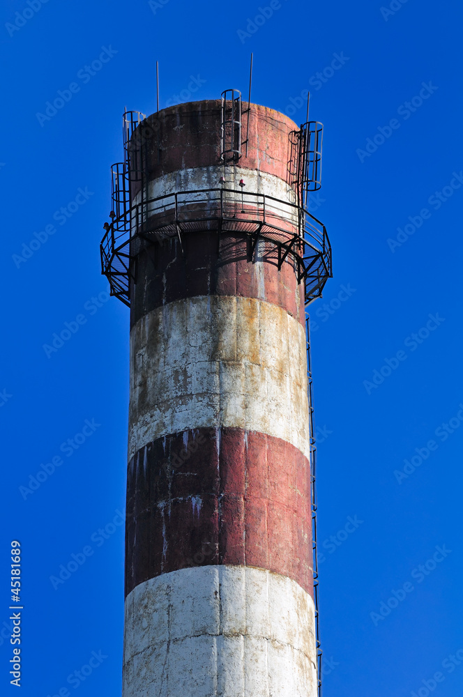 Industrial Smokestack on Blue Sky Background Industrial Smokestack on Blue Sky Background