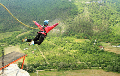 Jump off a cliff with a rope.