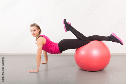 Athletic young woman with red ball