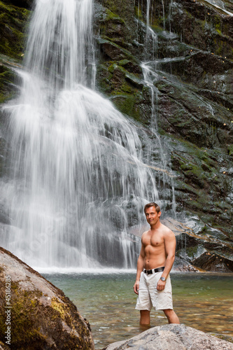 young man and waterfall