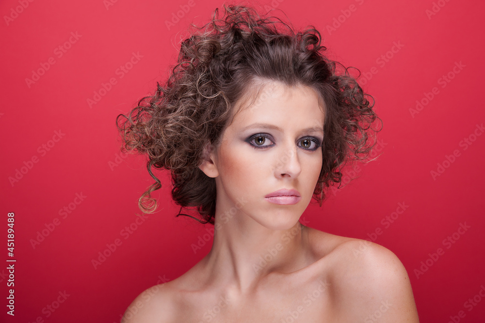 young and beautiful woman, with curly hair, on red young and beautiful woman, with curly hair, on red