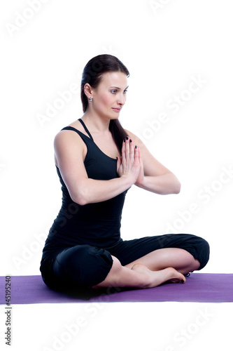 woman in a traditional yoga pose on white background
