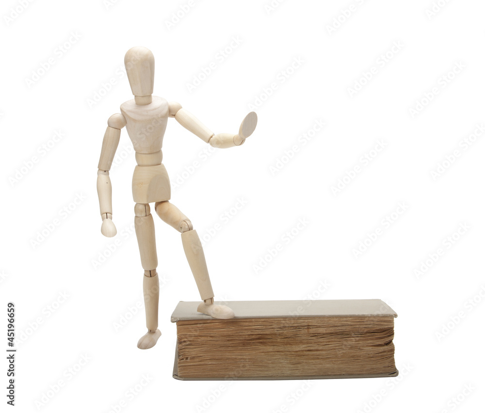 Wooden man and book, isolated on white Wooden man and book, isolated on white