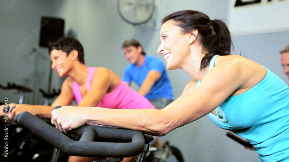 Gym Members Riding Exercise Bicycle Gym Members Riding Exercise Bicycle