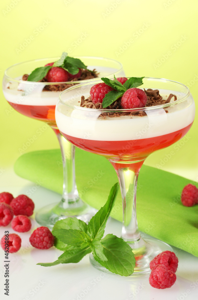 fruit jelly with berries in glasses on green background fruit jelly with berries in glasses on green background