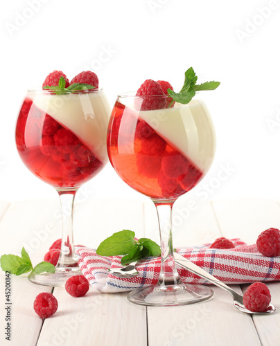 fruit jelly with raspberries in glasses on wooden table