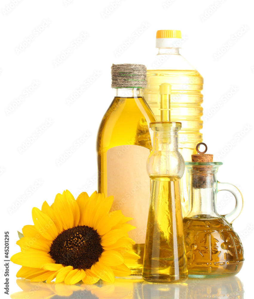 oil in jars and sunflower, isolated on white oil in jars and sunflower, isolated on white
