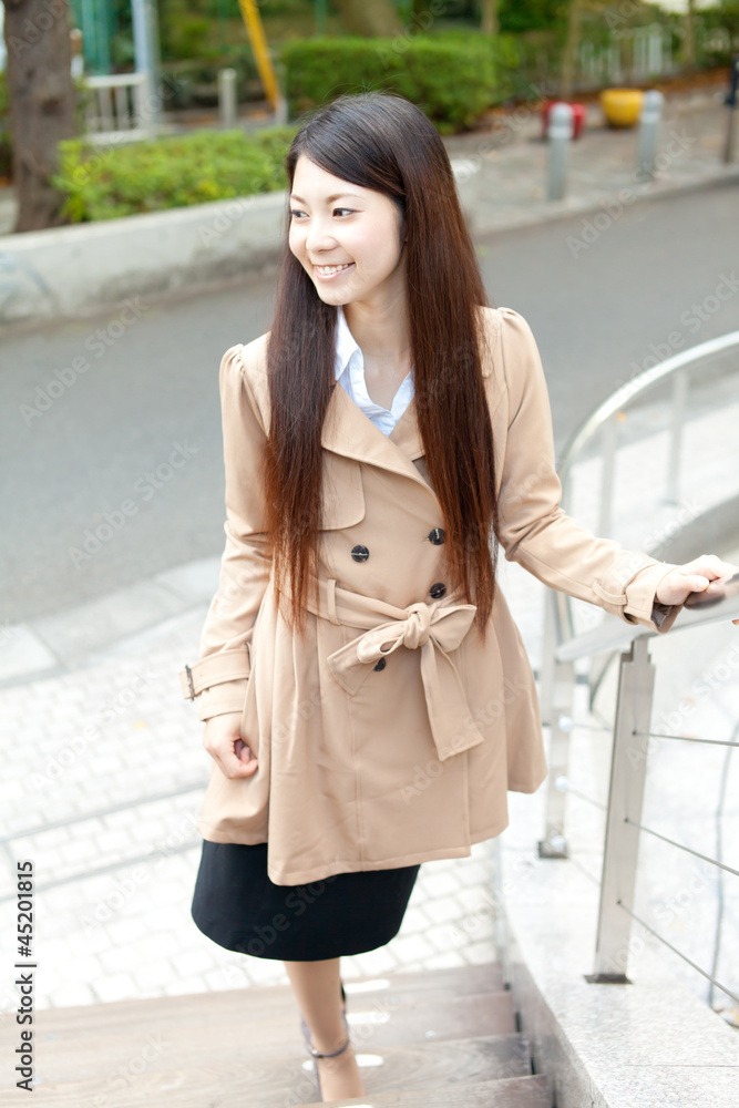 Fototapeta premium Beautiful business woman in the town. Portrait of asian.