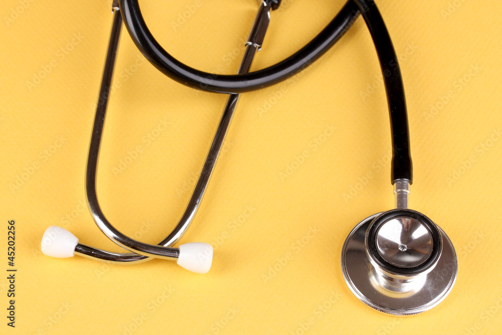 Stethoscope on orange background Stethoscope on orange background