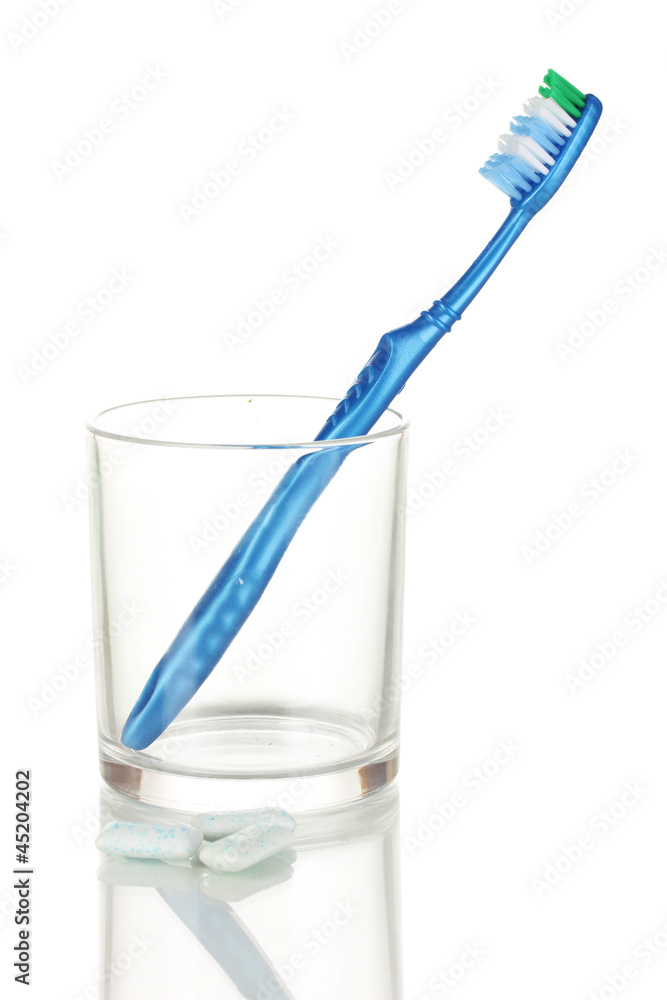 Toothbrush in glass and chewing gum isolated on white Toothbrush in glass and chewing gum isolated on white