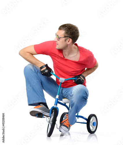 Cool man in glasses on a children's bicycle, white background