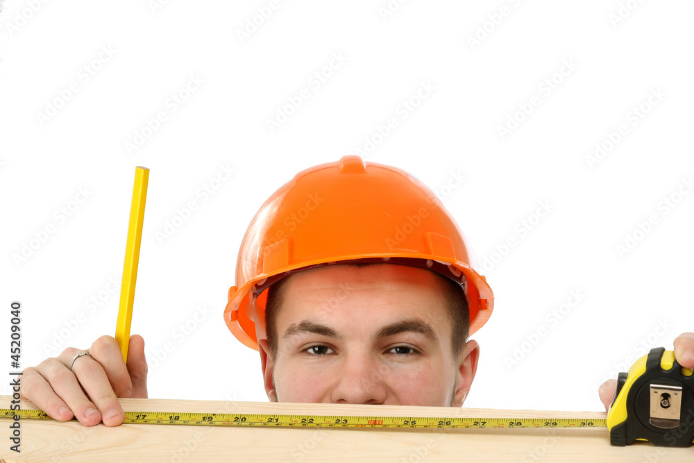 A young construcation worker measuring A young construcation worker measuring