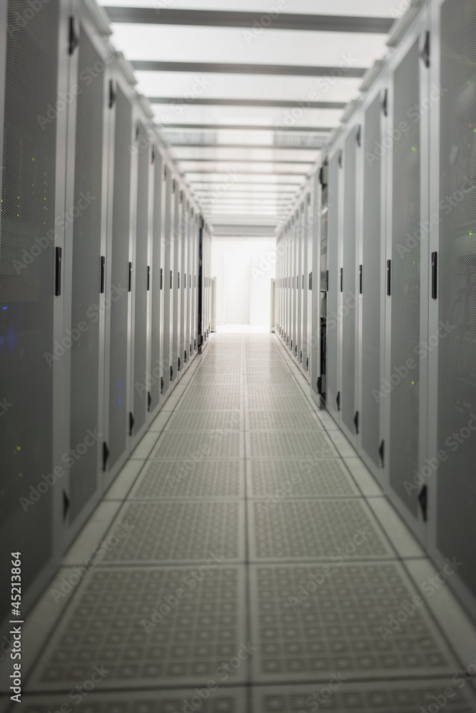 Hallway with a row of servers Hallway with a row of servers