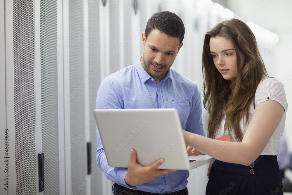 Two technicians looking at laptop Two technicians looking at laptop