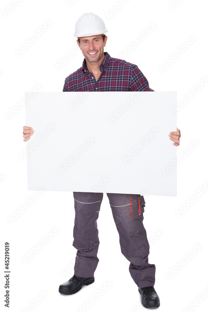 Man Wearing Hard Hat Holding Placard