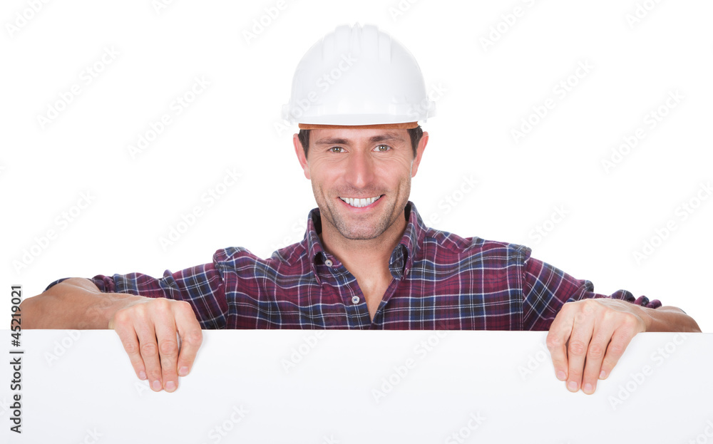 Man Wearing Hard Hat Holding Placard Man Wearing Hard Hat Holding Placard