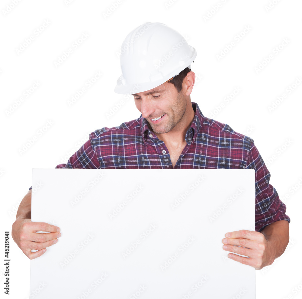 Man Wearing Hard Hat Holding Placard Man Wearing Hard Hat Holding Placard
